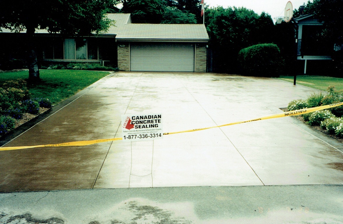Freshly restored concrete driveway completed by Canadian Concrete Sealing